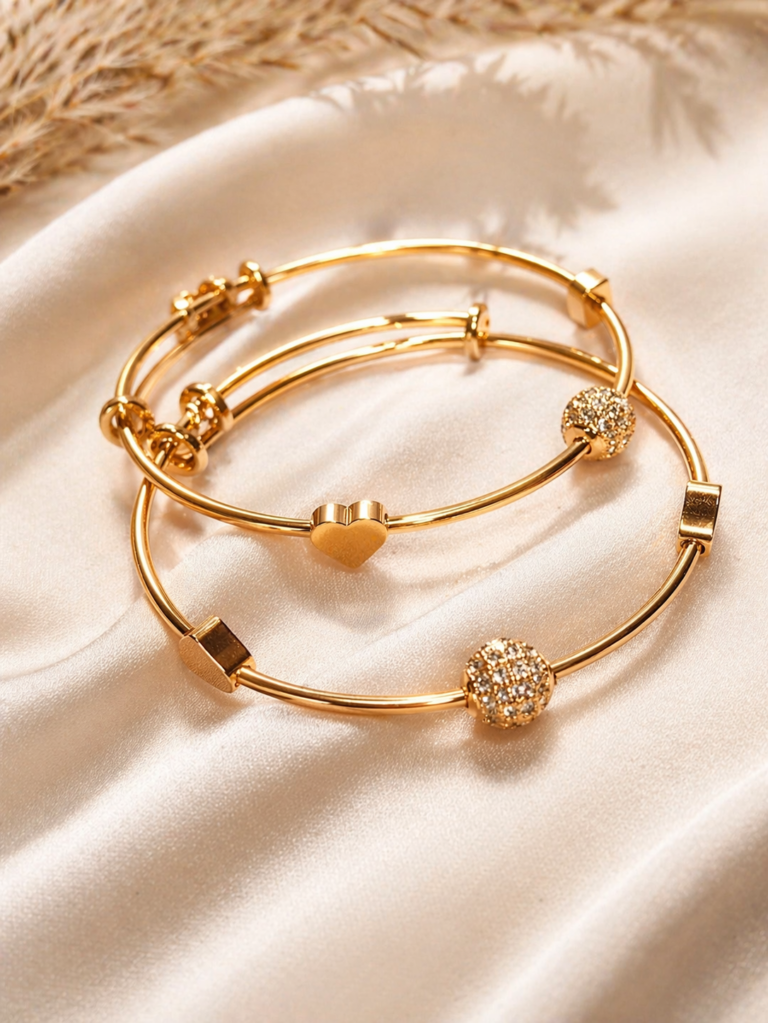 Elegant gold bangles on satin fabric