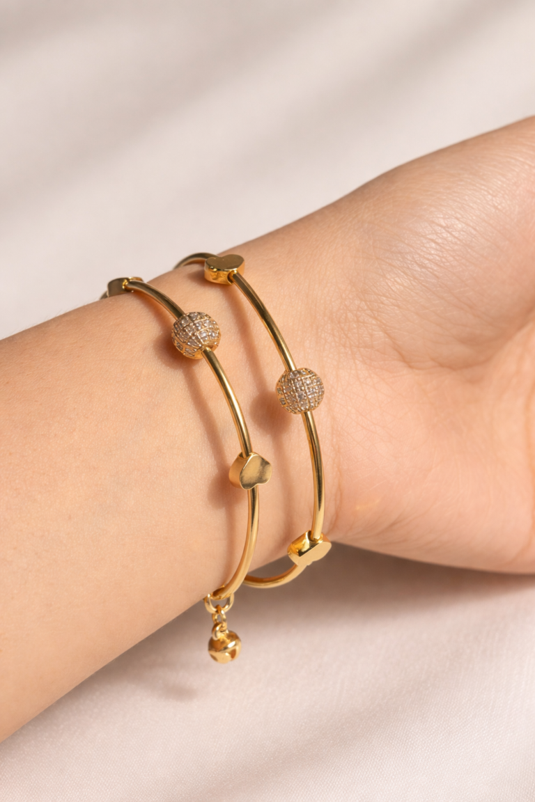 Elegant gold bangles on satin fabric